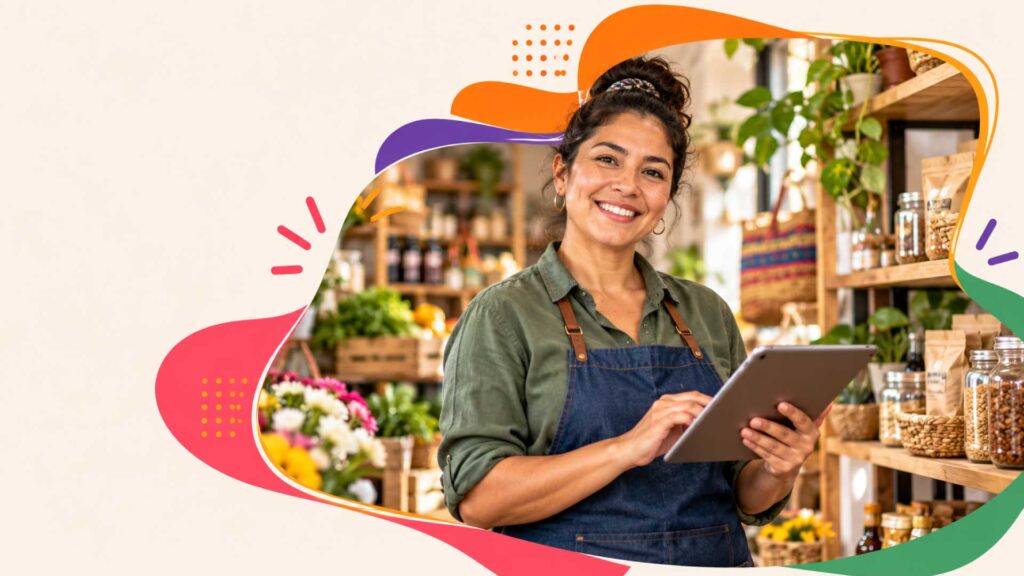 Emprendedora en su negocio con una tableta, imagen de la alianza entre Bancamía y la Cámara de la Diversidad.